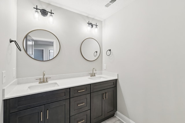 1373 Southside Rd, Southside, TN 37171 - bathroom with double vanity, marble look tile flooring, and baseboards