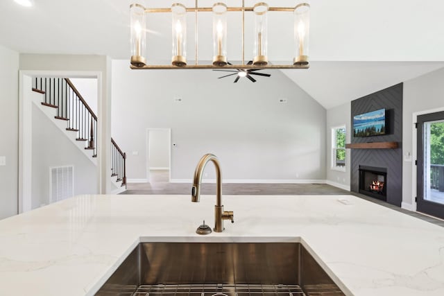 1373 Southside Rd, Southside, TN 37171 - kitchen with open floor plan, a sink, high vaulted ceiling, a large fireplace, and ceiling fan