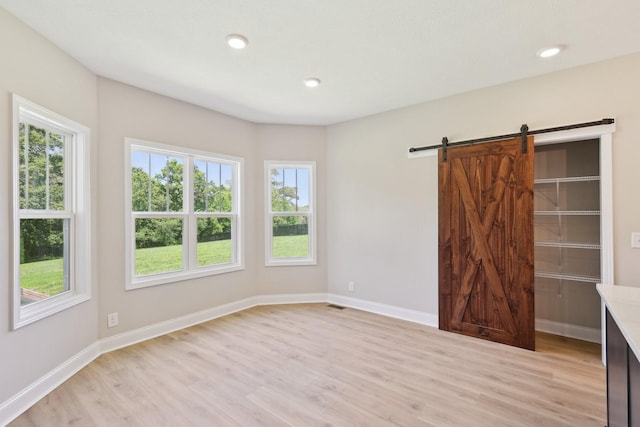 1373 Southside Rd, Southside, TN 37171 - unfurnished bedroom featuring light wood-style flooring, multiple windows, baseboards, and recessed lighting
