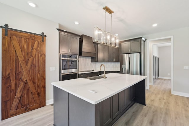 1373 Southside Rd, Southside, TN 37171 - kitchen with stainless steel appliances, custom exhaust hood, tasteful backsplash, light wood-style floors, and recessed lighting