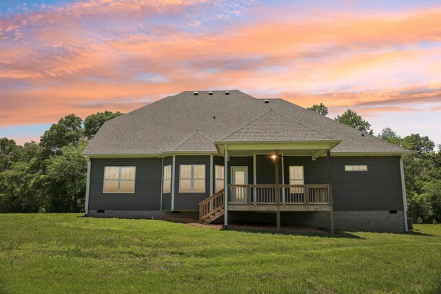 1373 Southside Rd, Southside, TN 37171 - back of house at dusk with crawl space, a yard, roof with shingles, and a wooden deck