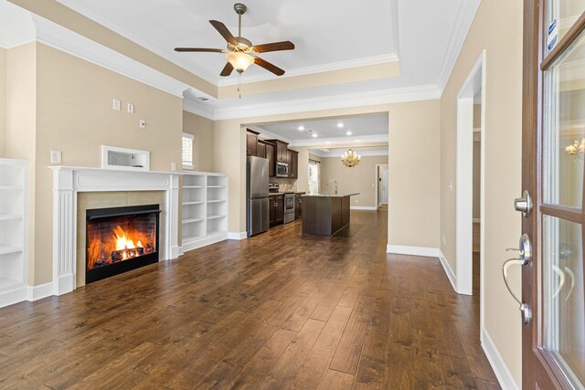 3216 Saltville Aly, Nolensville, TN 37135 - unfurnished living room featuring a raised ceiling, dark wood-style floors, a tile fireplace, crown molding, and ceiling fan