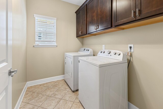 3216 Saltville Aly, Nolensville, TN 37135 - laundry area featuring washer and clothes dryer, cabinet space, baseboards, and light tile patterned floors