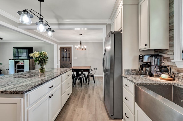 1430 Blythe Ferry Rd NE, Cleveland, TN 37312 - kitchen featuring freestanding refrigerator, white cabinetry, stone counters, light wood-style flooring, and hanging light fixtures