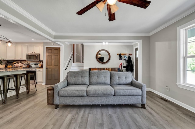 1430 Blythe Ferry Rd NE, Cleveland, TN 37312 - living area featuring ceiling fan, light wood finished floors, ornamental molding, baseboards, and stairway