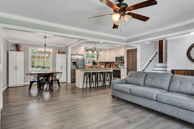 1430 Blythe Ferry Rd NE, Cleveland, TN 37312 - living area with a chandelier, ceiling fan, dark wood-style floors, baseboards, and crown molding