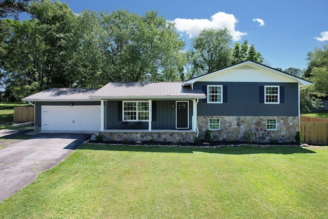 1430 Blythe Ferry Rd NE, Cleveland, TN 37312 - tri-level home with driveway, stone siding, a garage, and metal roof