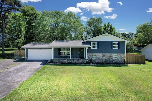 1430 Blythe Ferry Rd NE, Cleveland, TN 37312 - split level home with asphalt driveway, a garage, stone siding, and metal roof