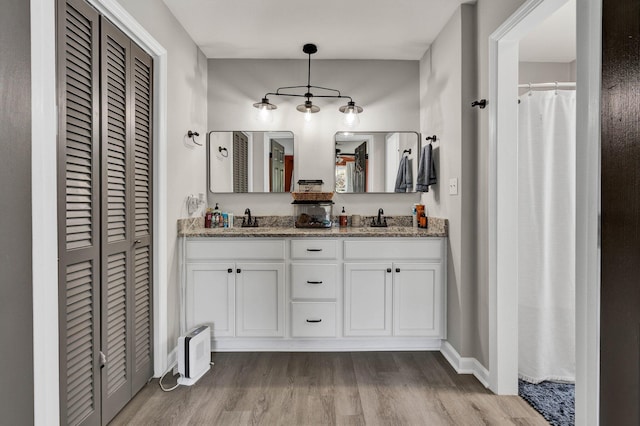 1430 Blythe Ferry Rd NE, Cleveland, TN 37312 - full bathroom featuring a closet, wood finished floors, double vanity, and baseboards