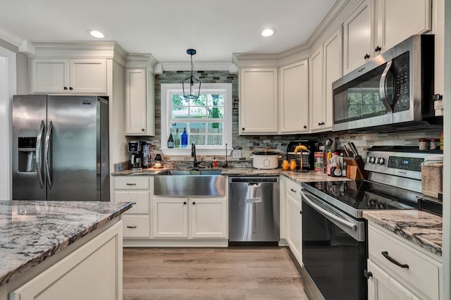 1430 Blythe Ferry Rd NE, Cleveland, TN 37312 - kitchen with stainless steel appliances, a sink, light wood-type flooring, backsplash, and light stone counters
