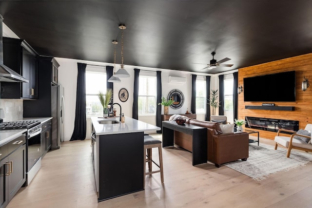 326A E Trinity Ln, Nashville, TN 37207 - living area with a ceiling fan, light wood finished floors, an AC wall unit, and wooden walls