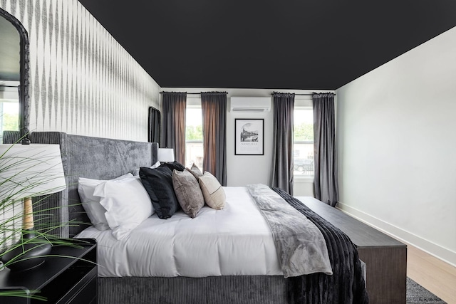 326A E Trinity Ln, Nashville, TN 37207 - bedroom featuring a wall mounted AC, wood finished floors, and baseboards