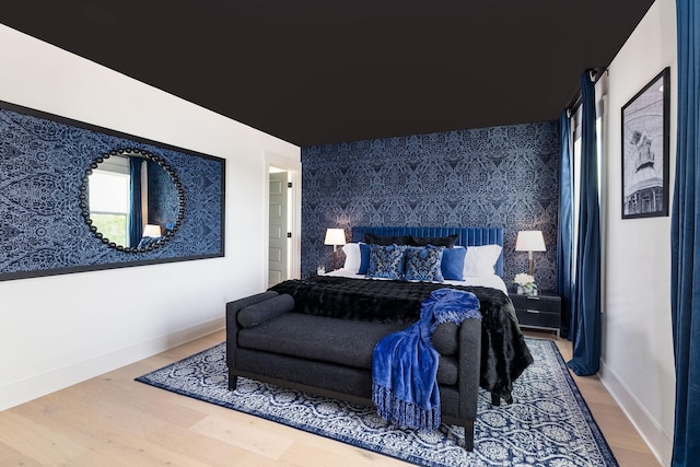 326A E Trinity Ln, Nashville, TN 37207 - bedroom featuring an accent wall, wood finished floors, baseboards, and wallpapered walls