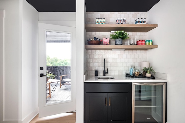 326A E Trinity Ln, Nashville, TN 37207 - indoor wet bar with beverage cooler, tasteful backsplash, and wood finished floors