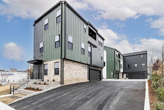 326A E Trinity Ln, Nashville, TN 37207 - view of building exterior with an attached garage and driveway