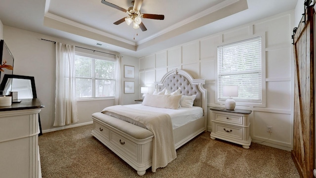 6614 Floral Ct, Murfreesboro, TN 37128 - carpeted bedroom with a barn door, a tray ceiling, crown molding, ceiling fan, and baseboards
