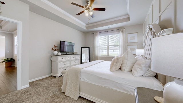6614 Floral Ct, Murfreesboro, TN 37128 - bedroom featuring ornamental molding, a raised ceiling, baseboards, a ceiling fan, and light carpet