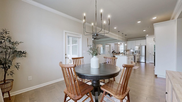 6614 Floral Ct, Murfreesboro, TN 37128 - dining room with light wood-style flooring, crown molding, a chandelier, recessed lighting, and baseboards