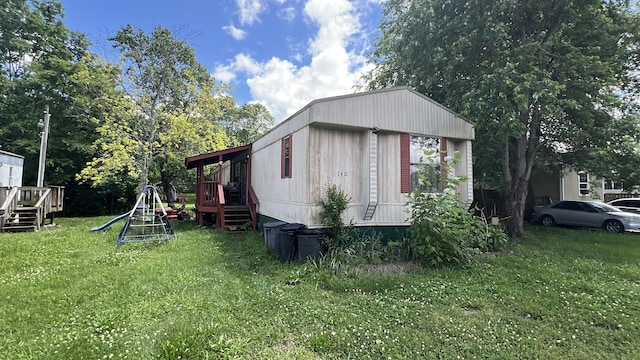 140 Plantation Dr, La Vergne, TN 37086 - view of side of property with a playground, a lawn, and a deck