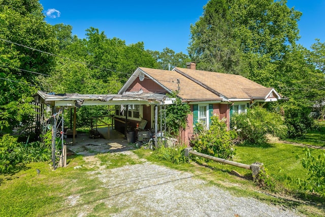 119 Westbrook Ave, Soddy Daisy, TN 37379 - view of front of property with driveway, a chimney, and an attached carport