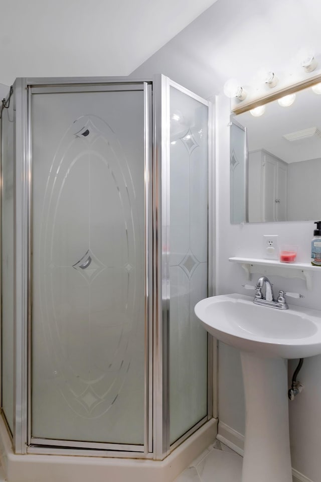 7464 Harrington Pl, Lyles, TN 37098 - full bathroom with a shower stall, a sink, baseboards, and tile patterned floors