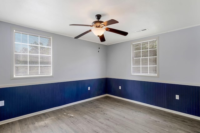 7464 Harrington Pl, Lyles, TN 37098 - empty room with a wainscoted wall, wood finished floors, ceiling fan, ornamental molding, and baseboards