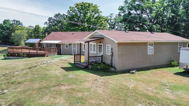 7464 Harrington Pl, Lyles, TN 37098 - rear view of house featuring a wooden deck, a lawn, and roof with shingles