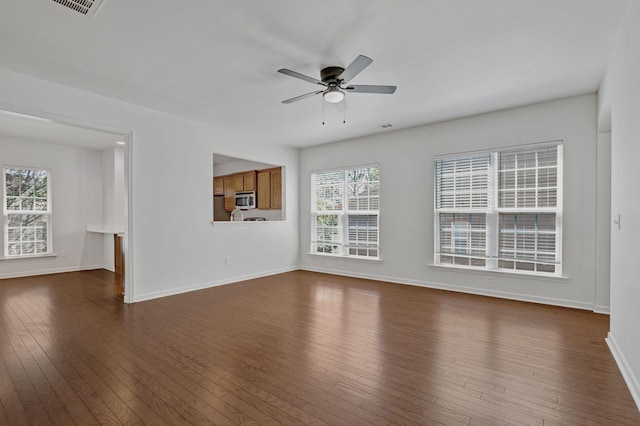 347 Blockade Ln, Mount Juliet, TN 37122 - unfurnished living room with dark wood-type flooring, plenty of natural light, a ceiling fan, and baseboards