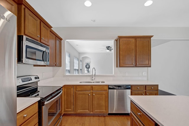 347 Blockade Ln, Mount Juliet, TN 37122 - kitchen with stainless steel appliances, a sink, light countertops, brown cabinets, and recessed lighting