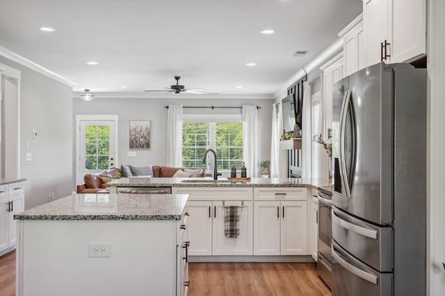 8035 Auburntown Rd, Auburntown, TN 37016 - kitchen featuring appliances with stainless steel finishes, a sink, open floor plan, a peninsula, and healthy amount of natural light