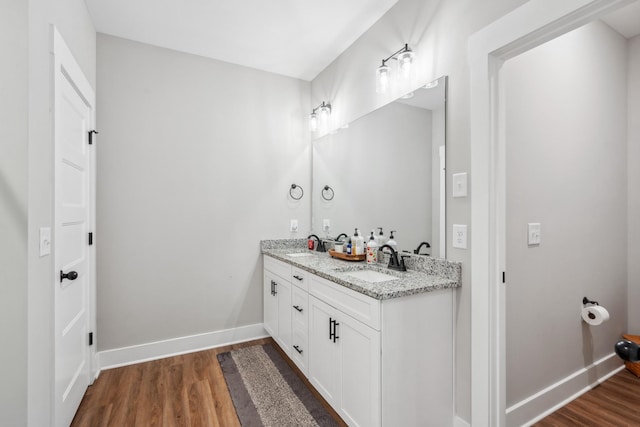 8035 Auburntown Rd, Auburntown, TN 37016 - bathroom with double vanity, wood finished floors, and baseboards