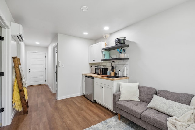 8035 Auburntown Rd, Auburntown, TN 37016 - indoor wet bar featuring a wall mounted air conditioner, dishwasher, wood finished floors, decorative backsplash, and recessed lighting