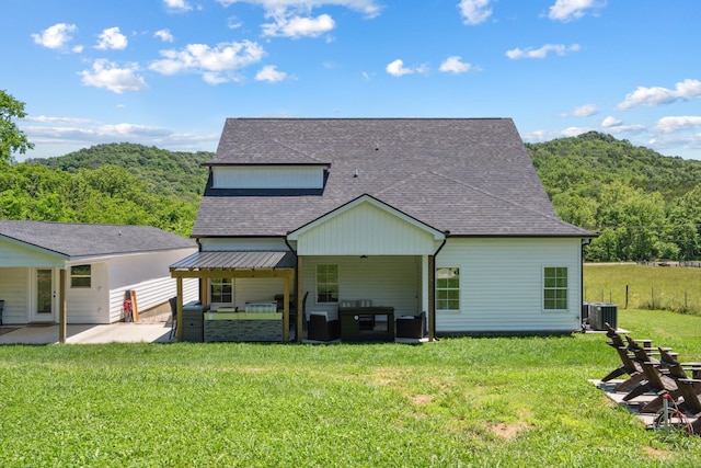 8035 Auburntown Rd, Auburntown, TN 37016 - rear view of property featuring central AC, a patio area, roof with shingles, an outdoor hangout area, and a lawn