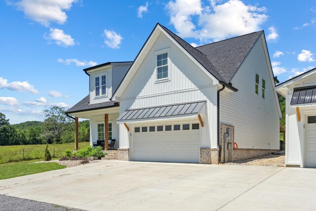 8035 Auburntown Rd, Auburntown, TN 37016 - modern inspired farmhouse with a shingled roof, a garage, concrete driveway, and a standing seam roof
