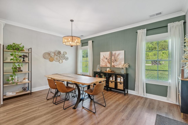 8035 Auburntown Rd, Auburntown, TN 37016 - dining space with light wood-style flooring, ornamental molding, baseboards, and a chandelier