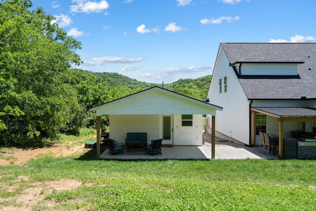 8035 Auburntown Rd, Auburntown, TN 37016 - rear view of house featuring roof with shingles, an outdoor living space, a patio, and a lawn
