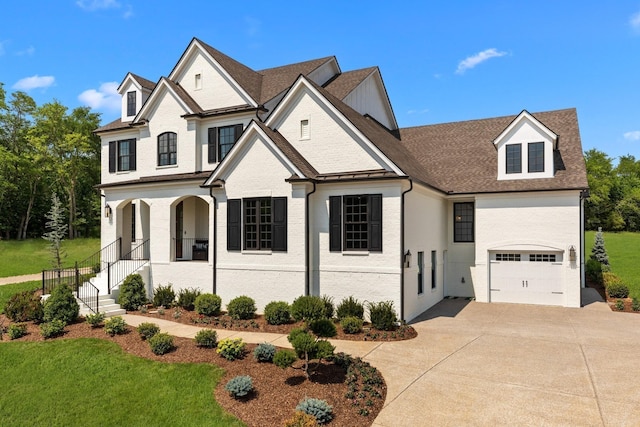 7243 Murrel Dr, Franklin, TN 37064 - french country style house featuring concrete driveway, a front yard, roof with shingles, and a porch