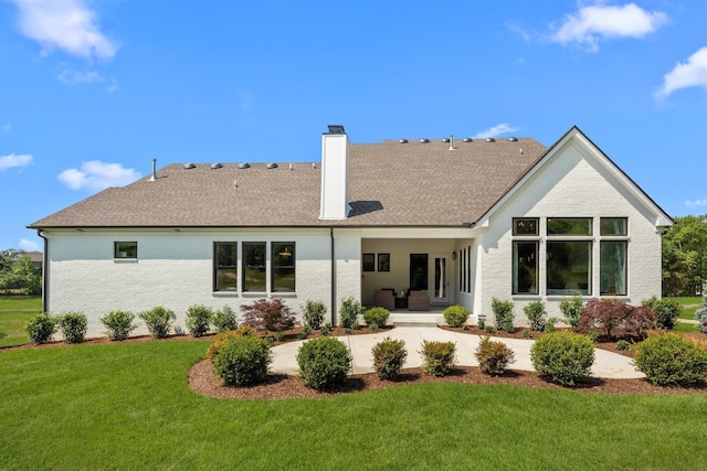 7243 Murrel Dr, Franklin, TN 37064 - rear view of house with a chimney, a yard, covered porch, and a shingled roof