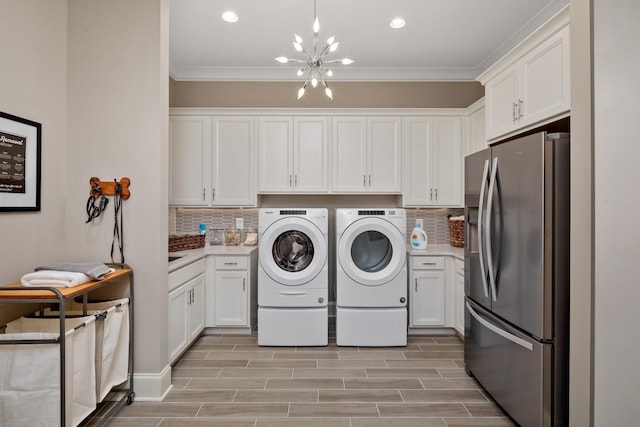 7243 Murrel Dr, Franklin, TN 37064 - laundry room with washer and clothes dryer, a chandelier, ornamental molding, recessed lighting, and light wood-type flooring
