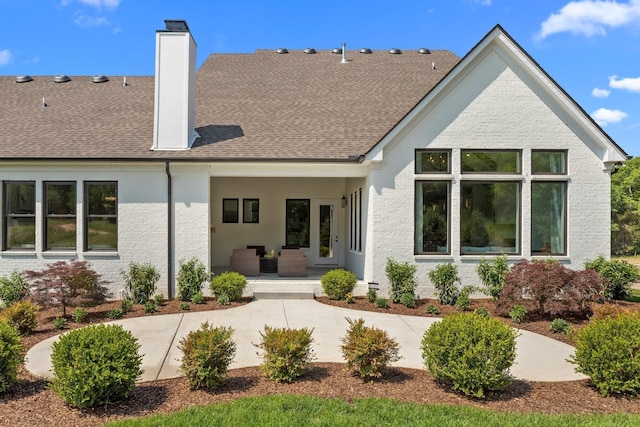 7243 Murrel Dr, Franklin, TN 37064 - rear view of house with a chimney, a patio, outdoor lounge area, and a shingled roof