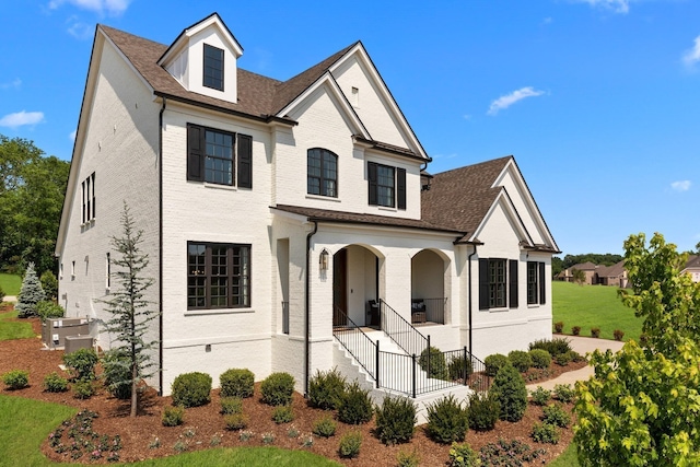 7243 Murrel Dr, Franklin, TN 37064 - view of front of property with covered porch, stairs, a front yard, and a shingled roof