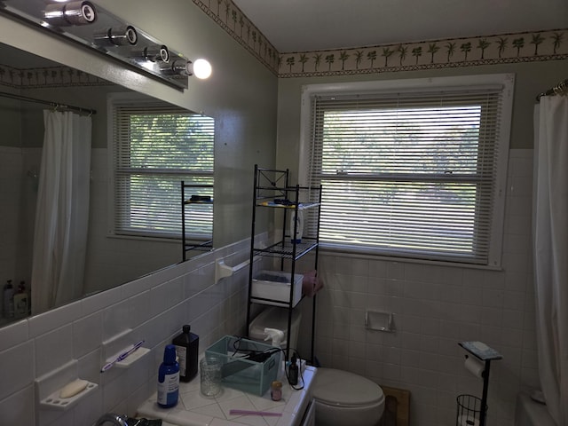 4548 Andrew Jackson Pkwy, Hermitage, TN 37076 - bathroom featuring tile walls, toilet, and wainscoting