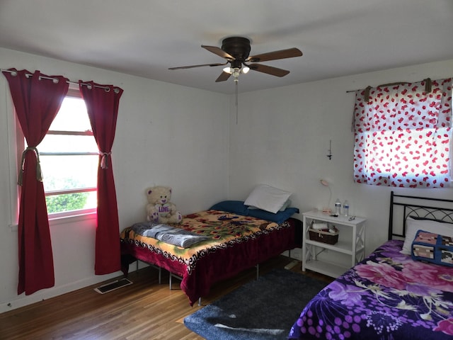 4548 Andrew Jackson Pkwy, Hermitage, TN 37076 - bedroom featuring wood finished floors, multiple windows, a ceiling fan, and baseboards