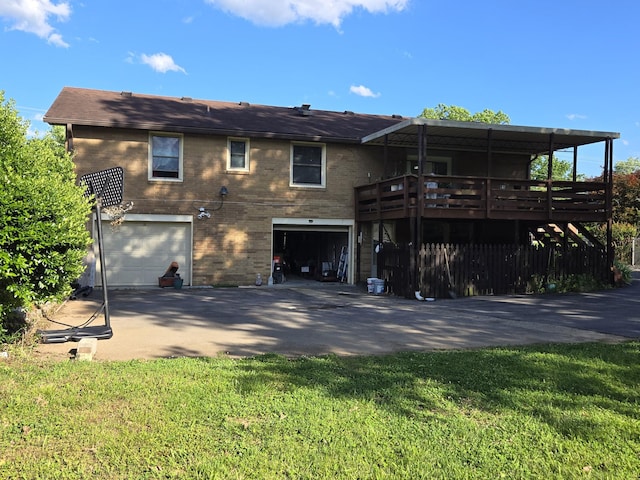 4548 Andrew Jackson Pkwy, Hermitage, TN 37076 - rear view of property featuring an attached garage, driveway, brick siding, a wooden deck, and a yard