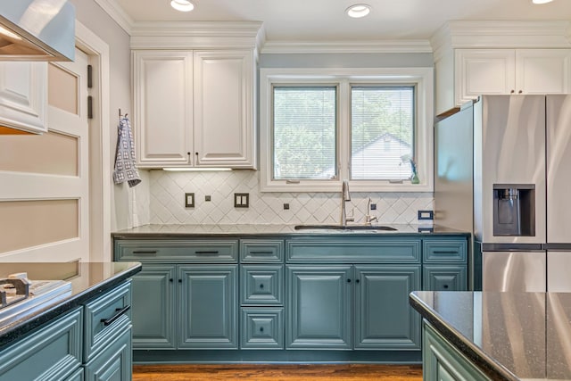 1135 Riverwood Dr, Nashville, TN 37216 - kitchen featuring stainless steel fridge with ice dispenser, a sink, white cabinets, backsplash, and crown molding