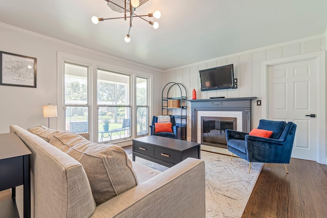 1135 Riverwood Dr, Nashville, TN 37216 - living room with crown molding, a fireplace with flush hearth, wood finished floors, and a chandelier