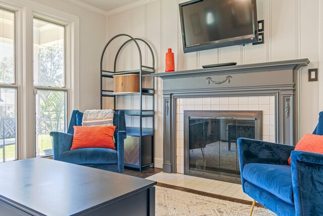 1135 Riverwood Dr, Nashville, TN 37216 - living area featuring ornamental molding, a tile fireplace, wood finished floors, and a decorative wall