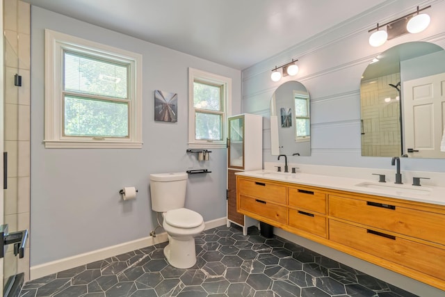 1135 Riverwood Dr, Nashville, TN 37216 - bathroom with double vanity, toilet, tiled shower, and baseboards