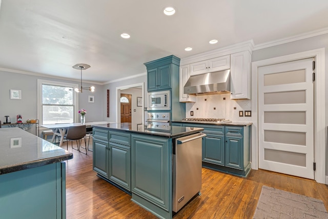 1135 Riverwood Dr, Nashville, TN 37216 - kitchen featuring stainless steel appliances, under cabinet range hood, a kitchen island, crown molding, and dark wood-type flooring