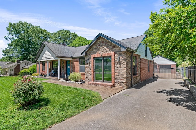 1135 Riverwood Dr, Nashville, TN 37216 - view of front of property with stone siding, a porch, a garage, brick siding, and roof with shingles